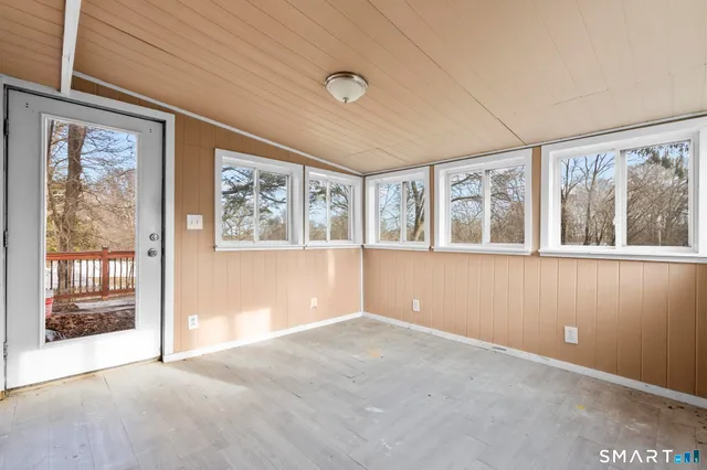 an empty room with large windows