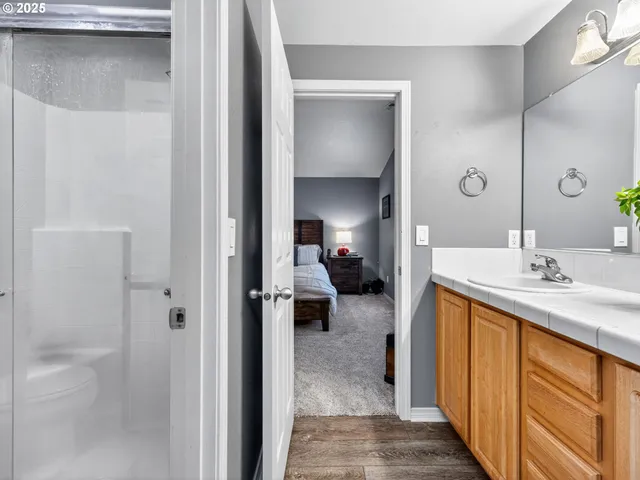 a en suite bathroom with a sink a mirror and a shower