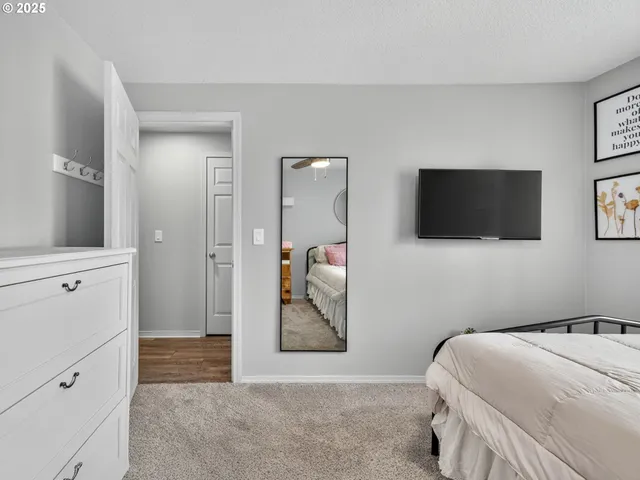 a bedroom with a bed and a flat screen tv