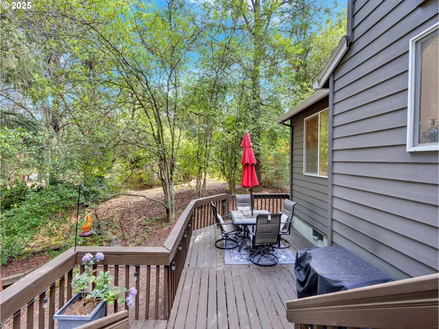 a view of deck with chairs and wooden fence