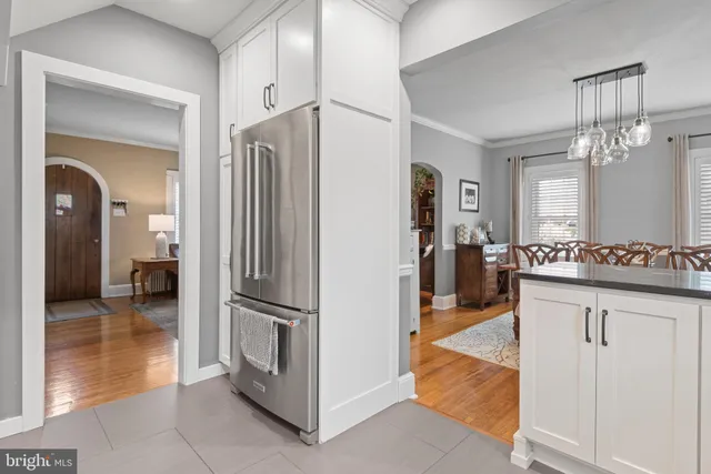 a view of a kitchen from the hallway and a livingroom