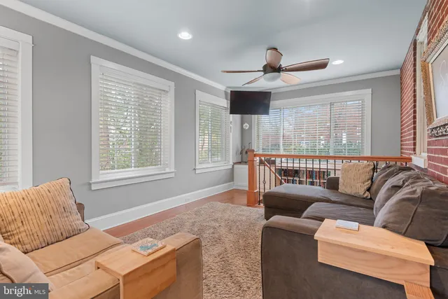 a bedroom with furniture and a large window