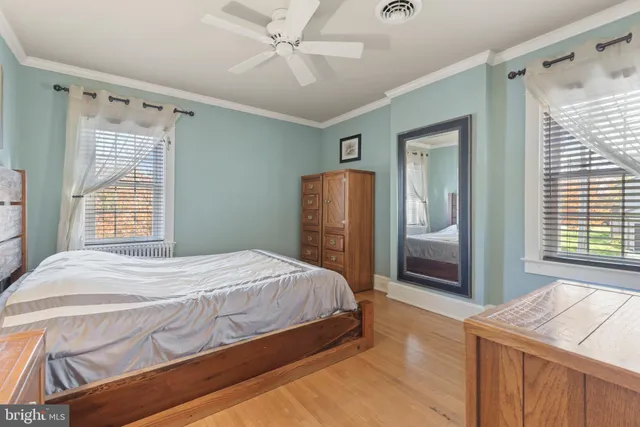 a bedroom with a bed and a mirror