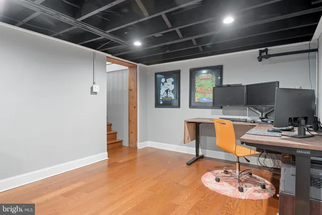 a workspace with furniture and wooden floor