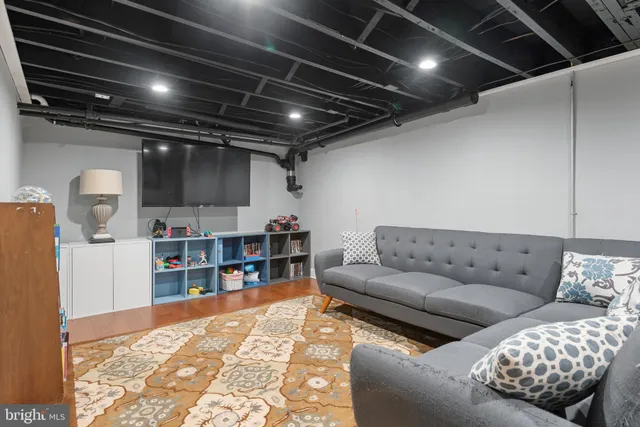 a living room with furniture and a book shelf