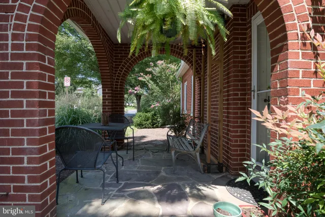 a view of a patio with table and chairs and potted plants