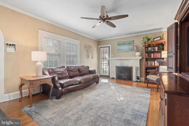 a living room with furniture a fireplace and a window