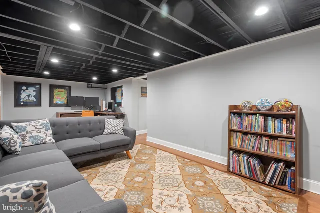 a living room with furniture and a book shelf
