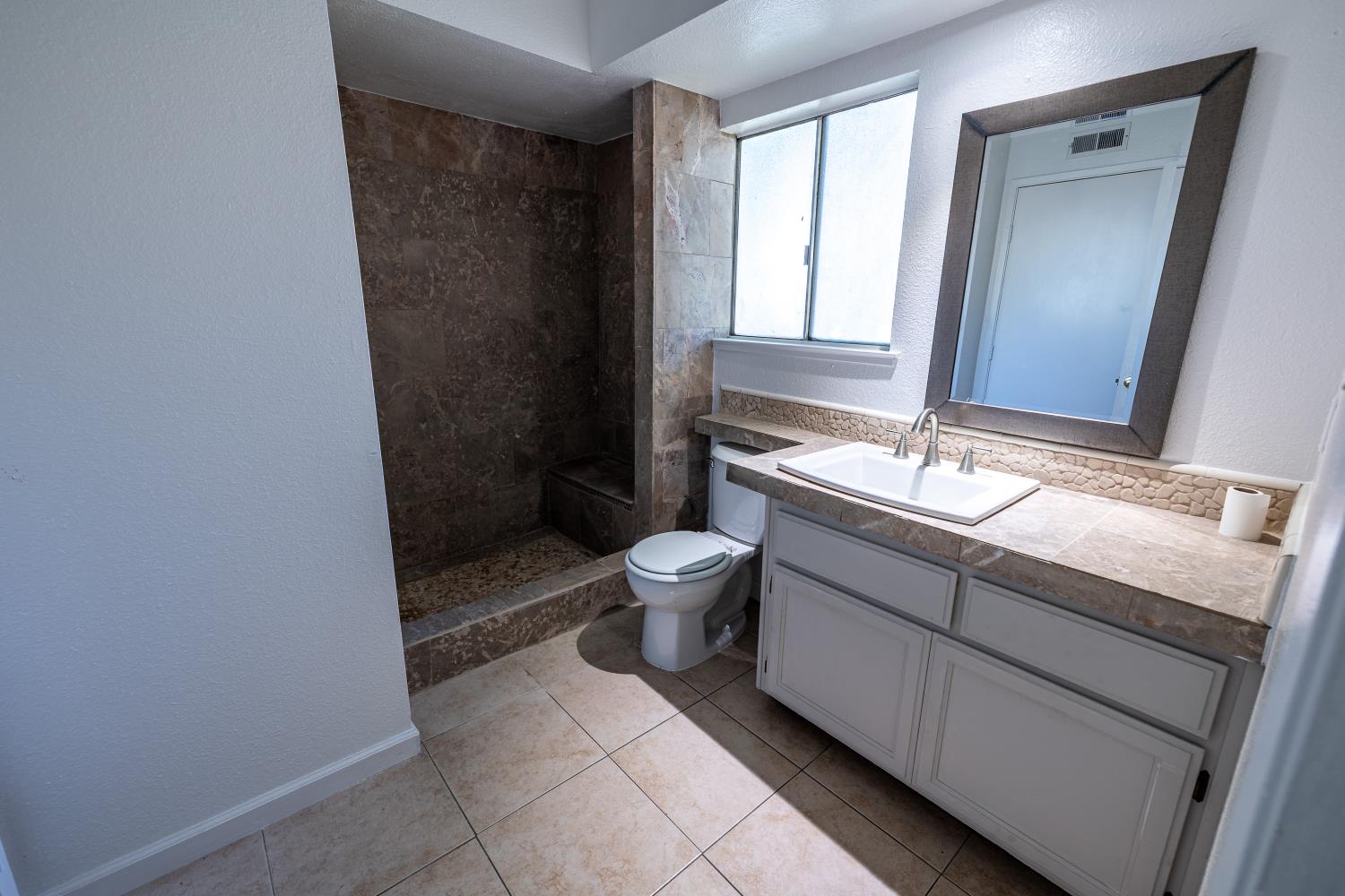 3700 Tully Road, Unit 5 Modesto, CA 95356 - Photo 19 of 38 a bathroom with a granite countertop sink toilet and shower