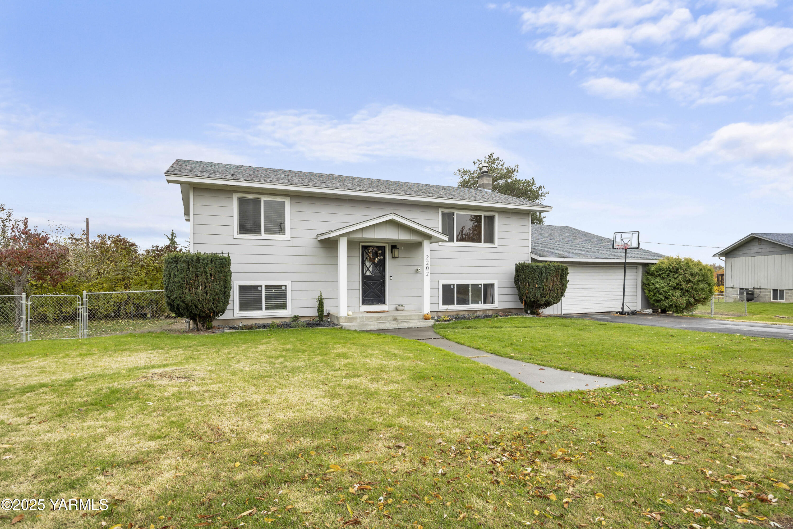 a view of a house with a yard and garage
