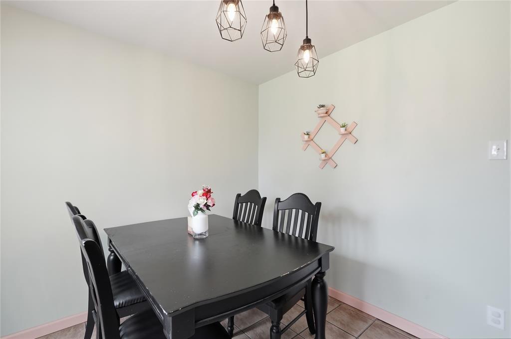 837 Springdale Road Bedford, TX 76021 - Photo 13 of 28 Dining area featuring light green walls and ceramic tile flooring