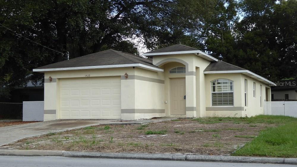 a front view of a house with garage
