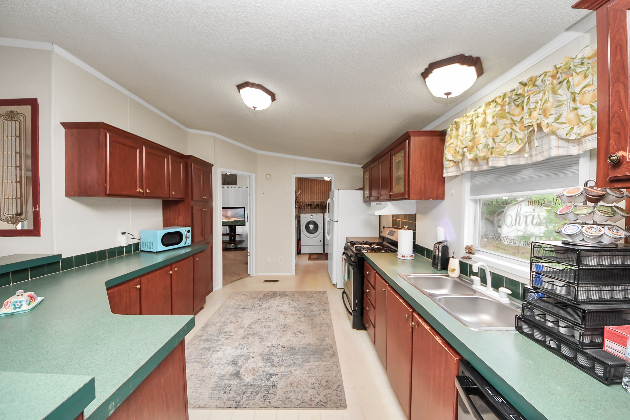 204 Edith Street Highlands, TX 77562 - Photo 23 of 33 a large kitchen with stainless steel appliances granite countertop a stove refrigerator and a sink