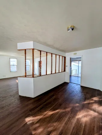 a large white bed sitting in a room next to a window
