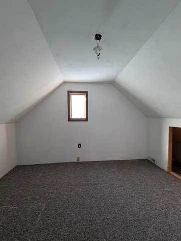 an empty room with a empty space and windows