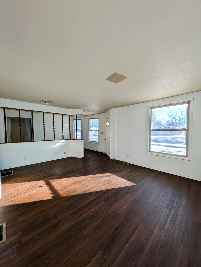 543 East 3rd Street El Paso, IL 61738 - Photo 10 of 21 a view of an empty room with wooden floor and a window