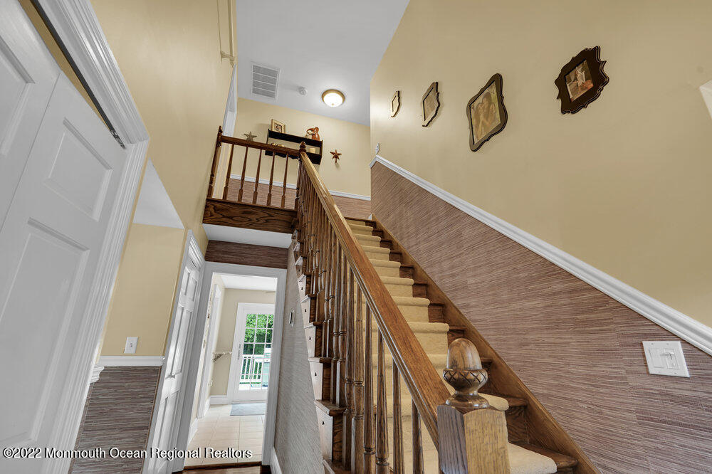 1722 Burrsville Road Brick, NJ 08724 - Photo 13 of 71 a view of staircase with lots of frames on wall and a window