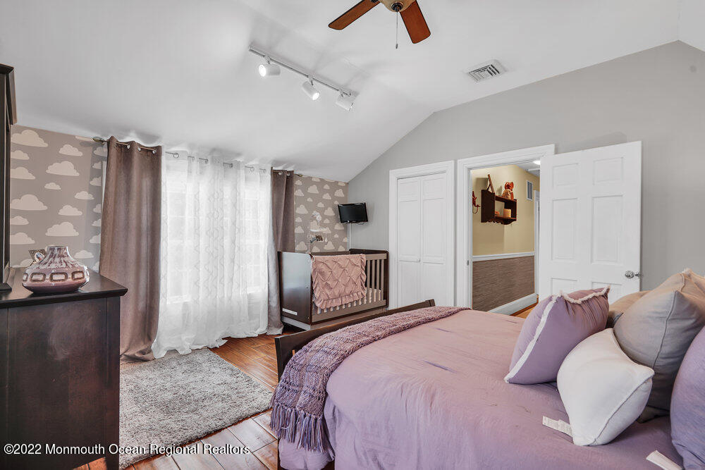 1722 Burrsville Road Brick, NJ 08724 - Photo 39 of 71 a bedroom with a large bed and a couch