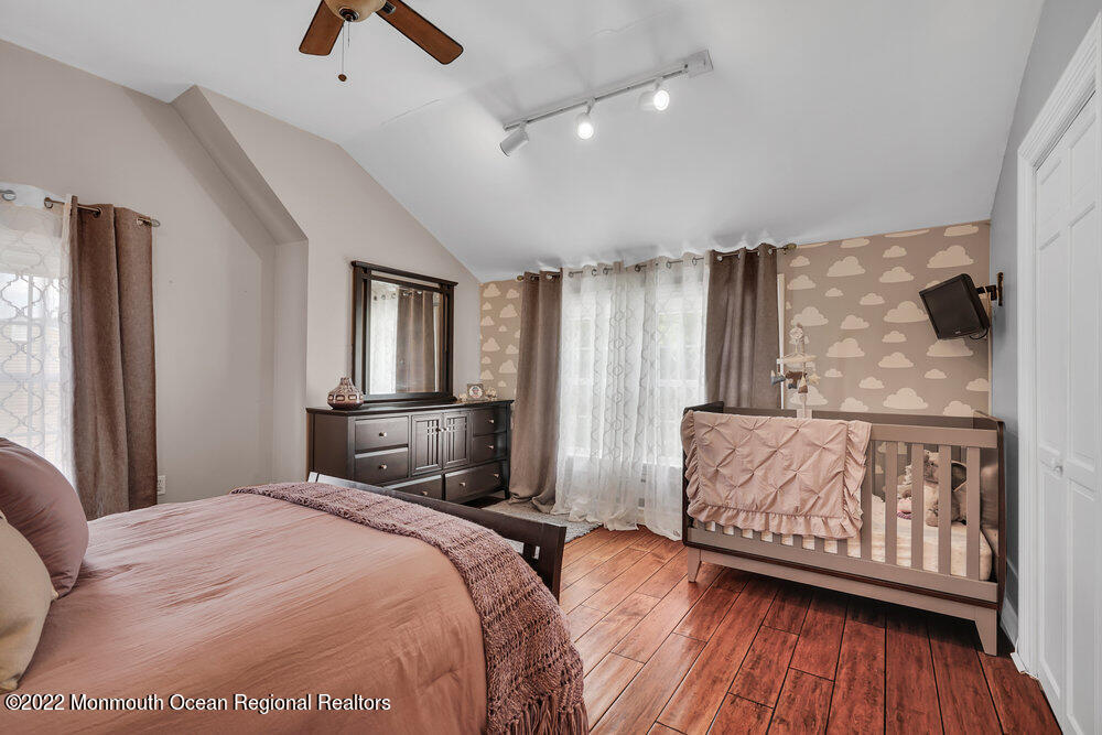 1722 Burrsville Road Brick, NJ 08724 - Photo 41 of 71 a bedroom with a large bed and a wooden floor