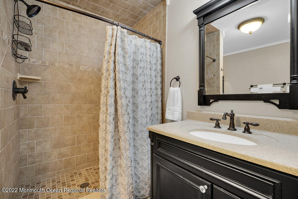1722 Burrsville Road Brick, NJ 08724 - Photo 44 of 71 a bathroom with a sink and a mirror