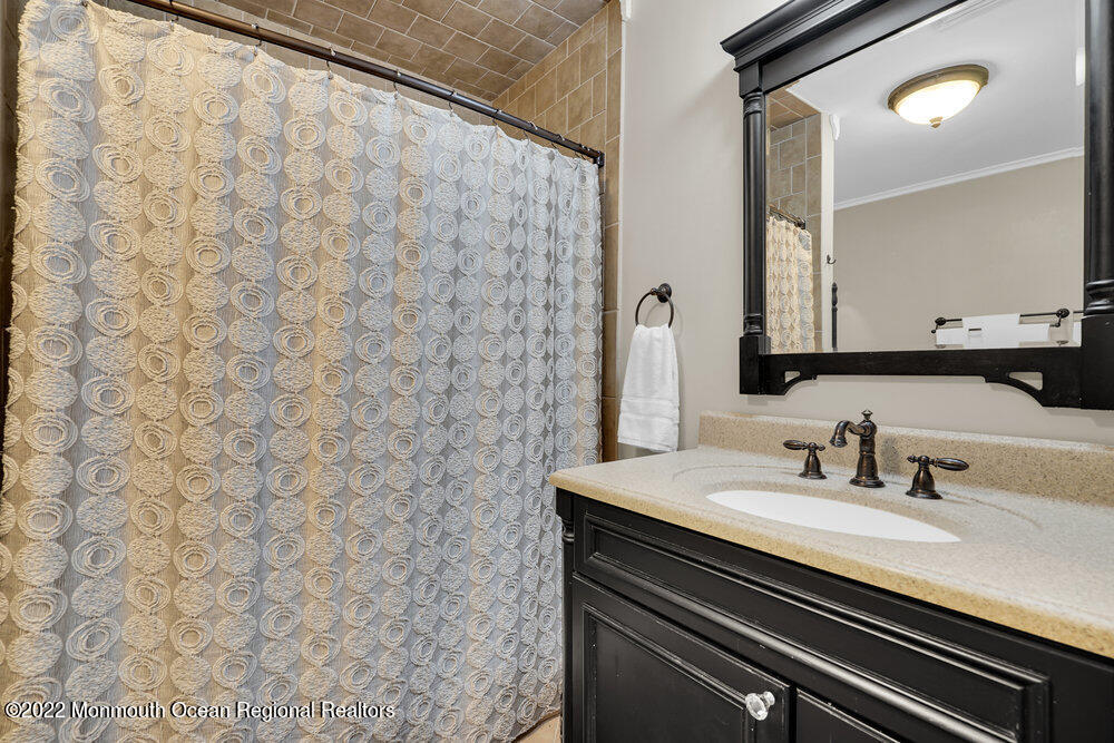 1722 Burrsville Road Brick, NJ 08724 - Photo 45 of 71 a bathroom with a sink and a mirror