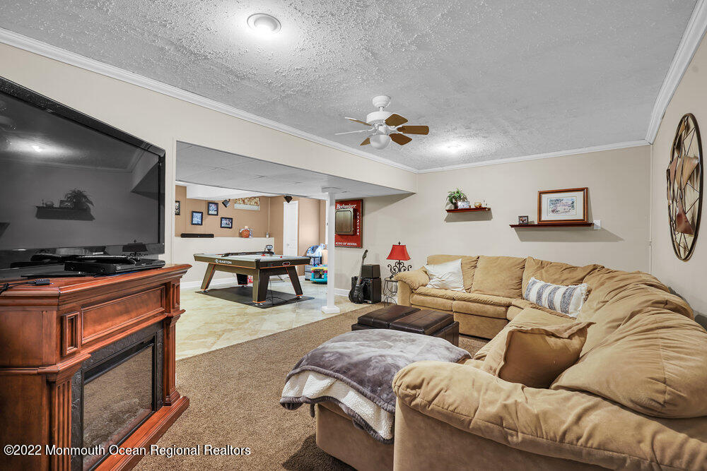 1722 Burrsville Road Brick, NJ 08724 - Photo 60 of 71 a living room with furniture and a flat screen tv