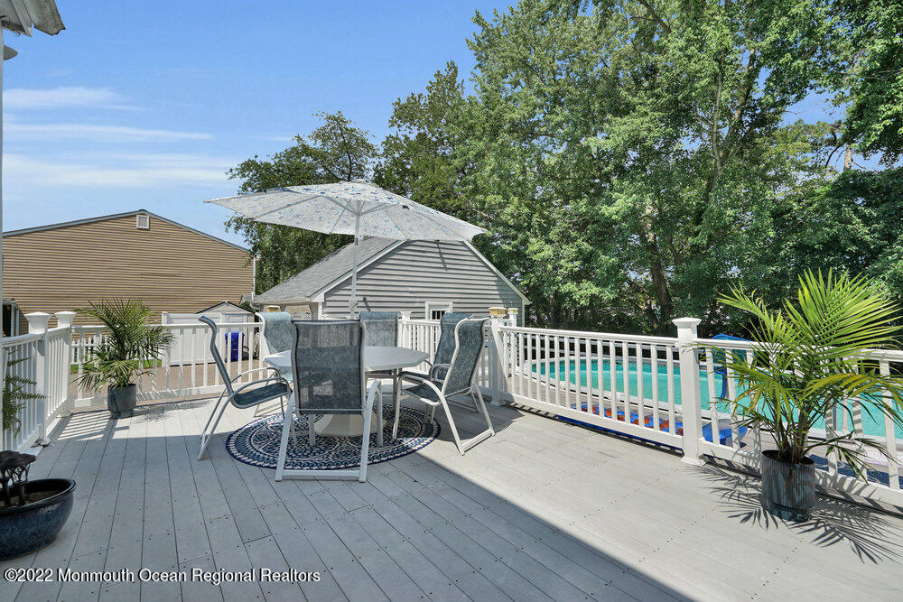 1722 Burrsville Road Brick, NJ 08724 - Photo 68 of 71 a view of a roof deck with table and chairs with wooden floor and fence