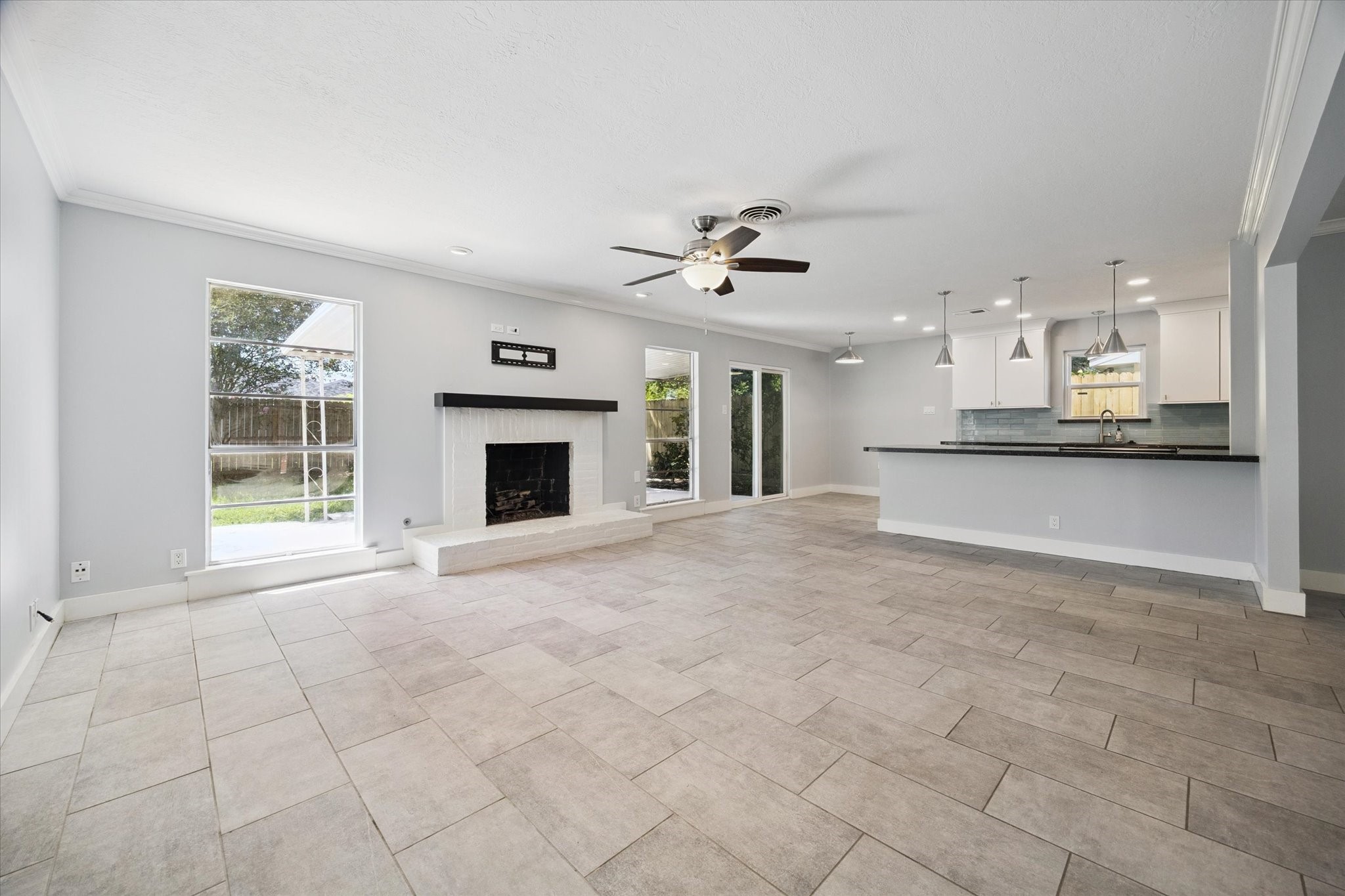 9407 Meadowbriar Lane Houston, TX 77063 - Photo 11 of 31 a view of a kitchen with furniture and a ceiling fan