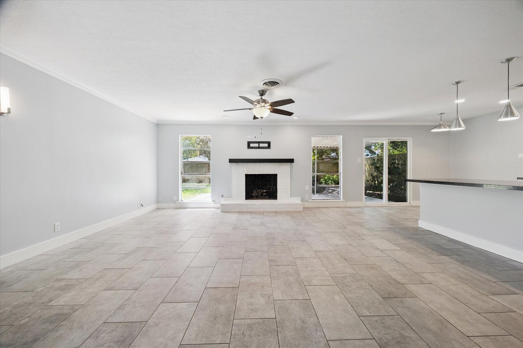 9407 Meadowbriar Lane Houston, TX 77063 - Photo 12 of 31 an empty room with fireplace and windows