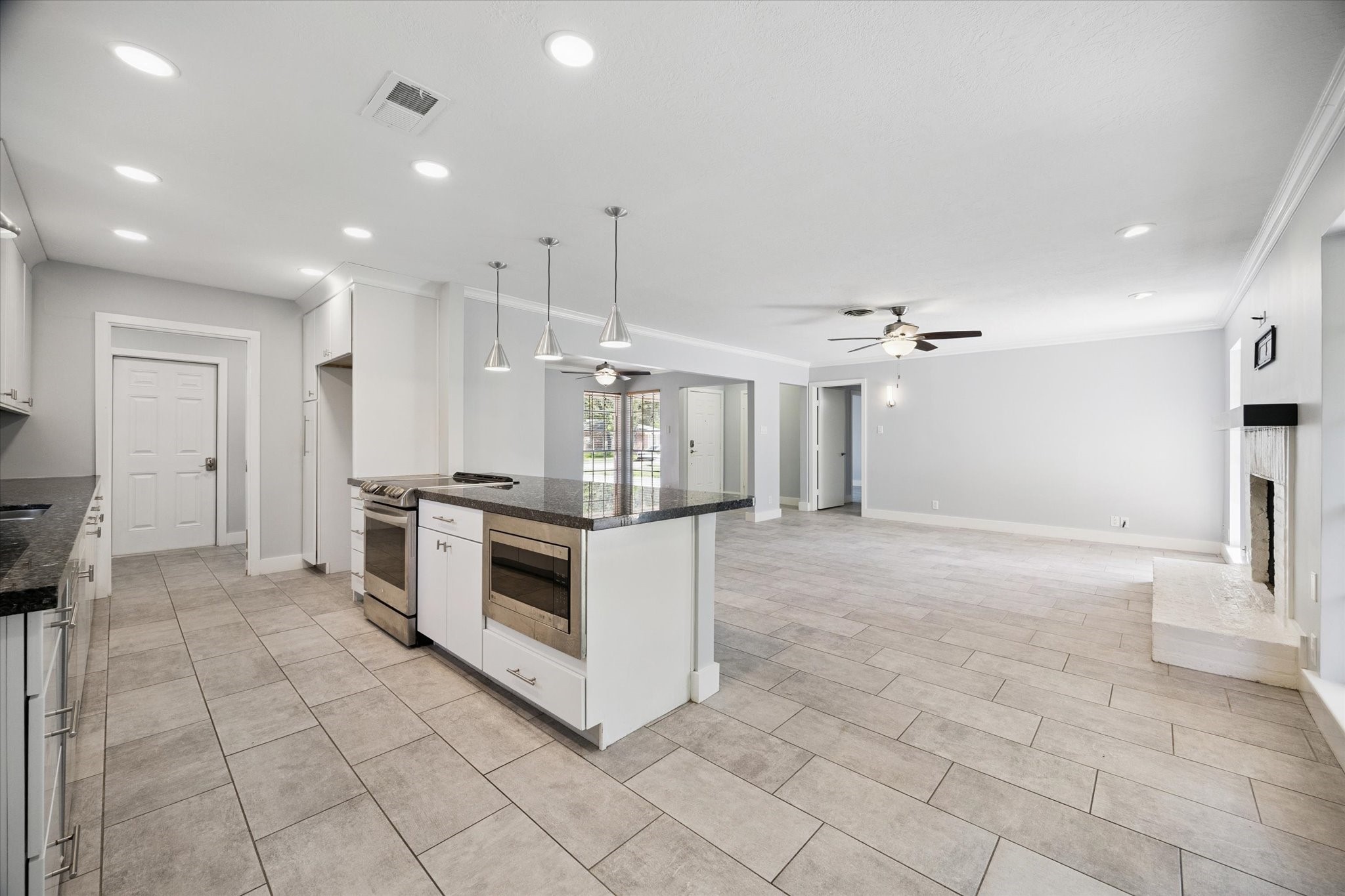 9407 Meadowbriar Lane Houston, TX 77063 - Photo 17 of 31 a large kitchen with granite countertop a stove a sink and a refrigerator