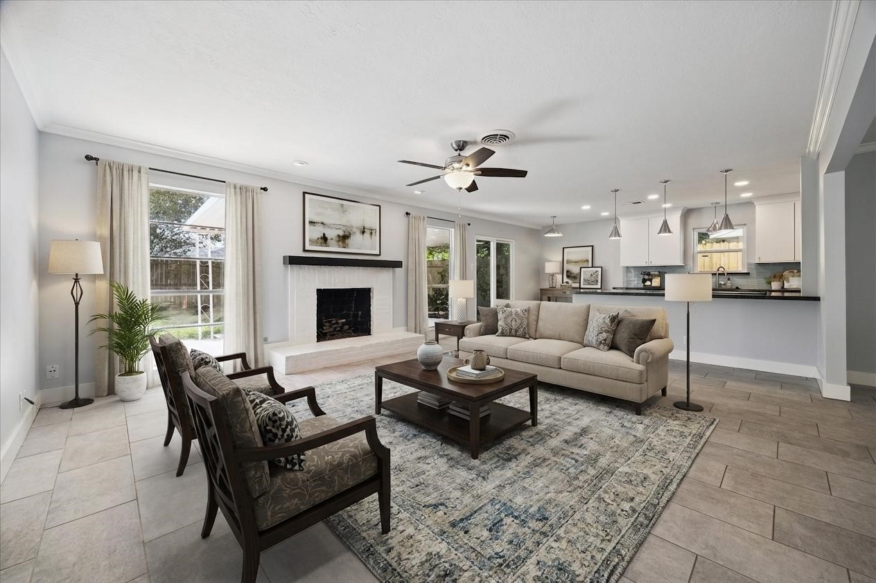 9407 Meadowbriar Lane Houston, TX 77063 - Photo 2 of 31 a living room with furniture kitchen view and a fireplace
