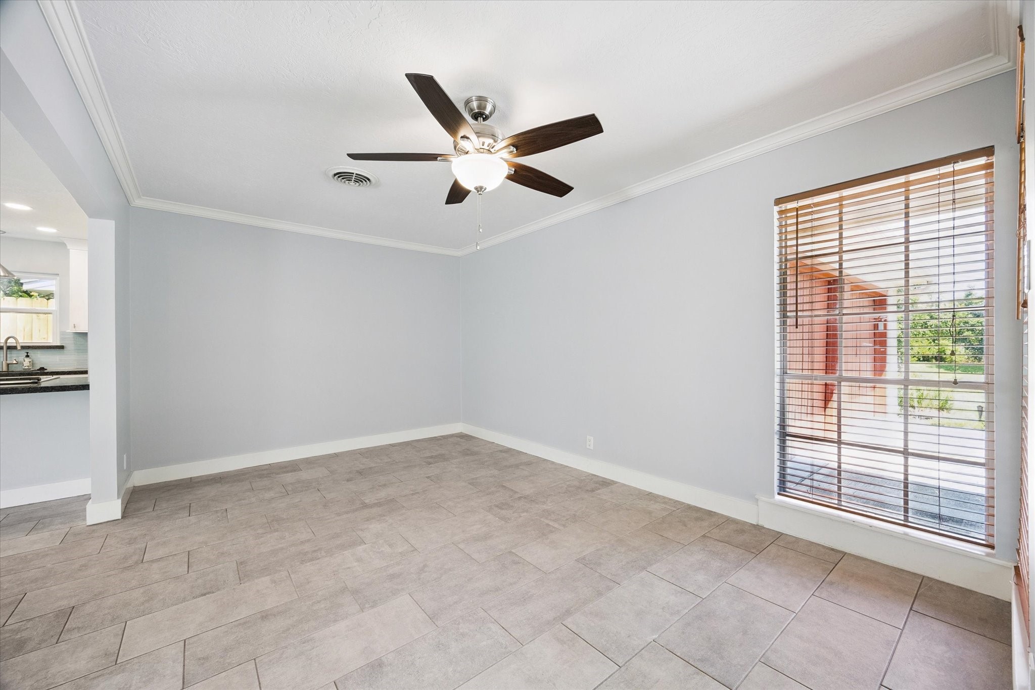 9407 Meadowbriar Lane Houston, TX 77063 - Photo 21 of 31 an empty room with windows and ceiling fan
