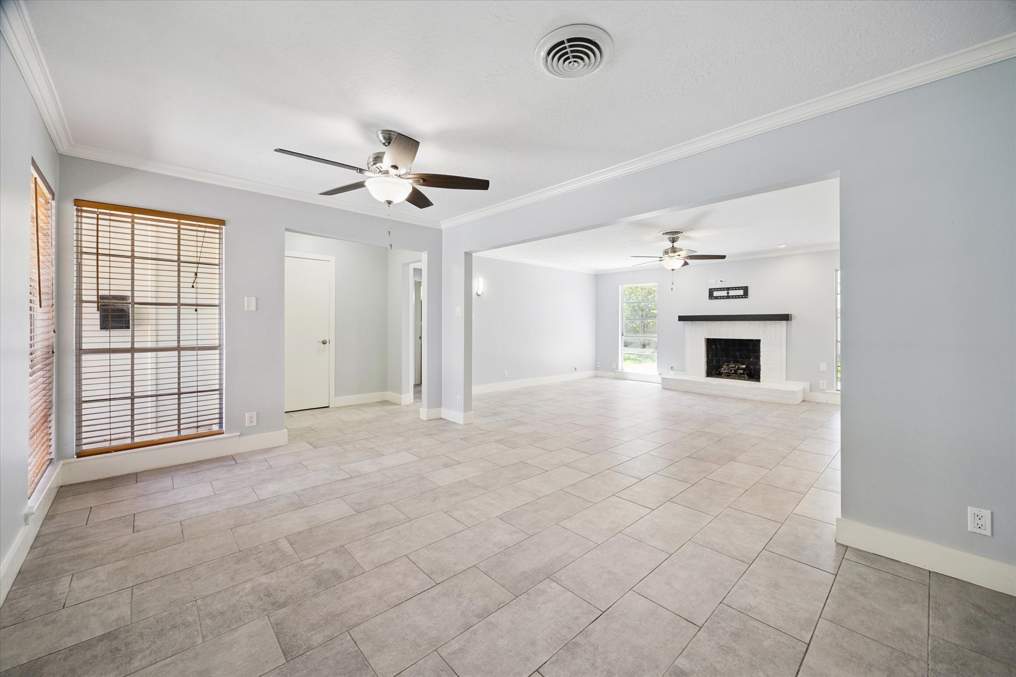 9407 Meadowbriar Lane Houston, TX 77063 - Photo 22 of 31 a view of empty room with a ceiling fan and window