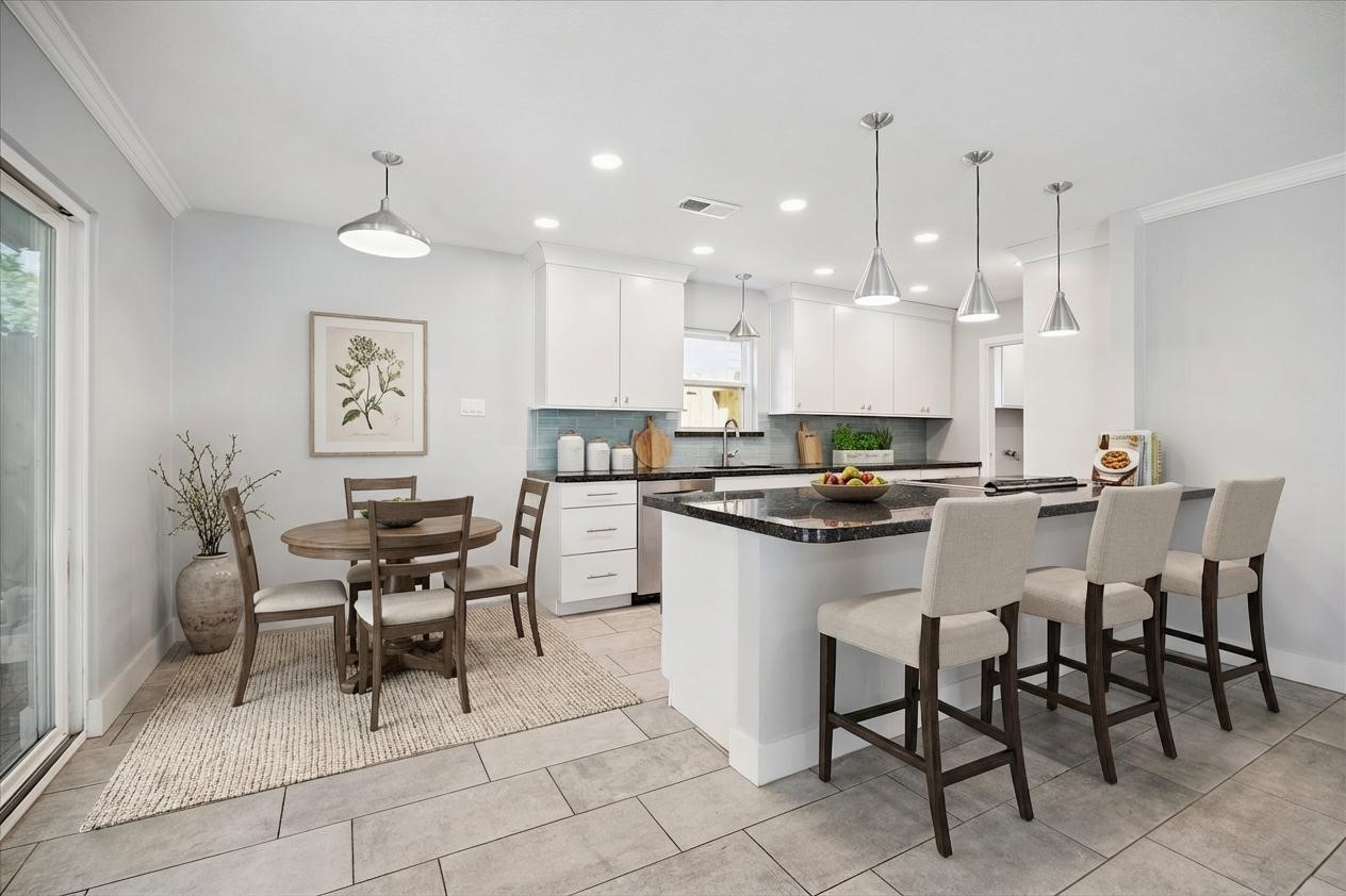 9407 Meadowbriar Lane Houston, TX 77063 - Photo 3 of 31 a kitchen with a dining table chairs and view kitchen