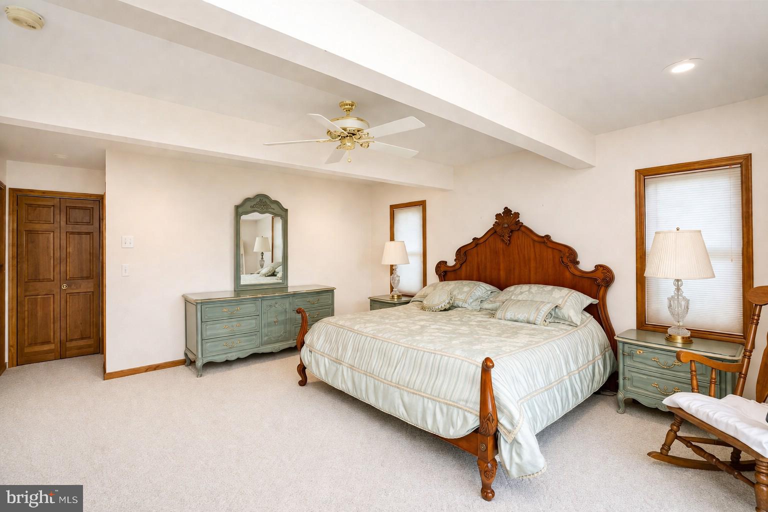 389 Sawmill Hollow Road Swanton, MD 21561 - Photo 21 of 62 a spacious bedroom with a bed and a chandelier