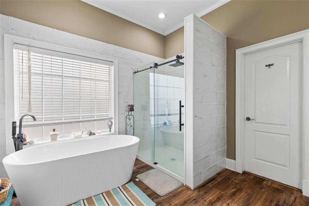 8399 East Carroll Road Whitesburg, GA 30185 - Photo 16 of 52 a bathroom with a bathtub and shower