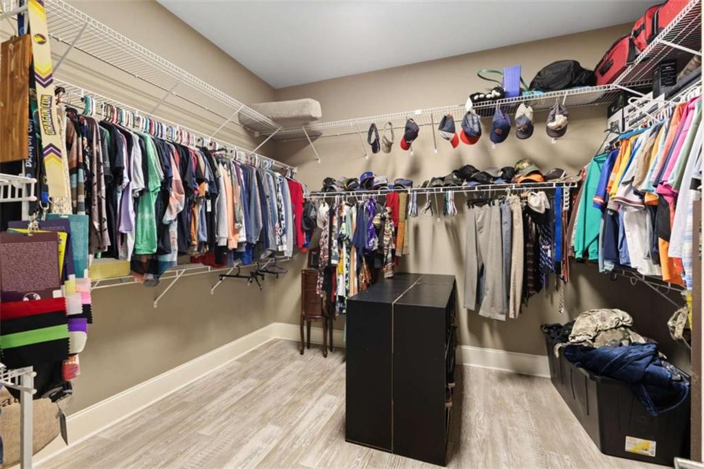 8399 East Carroll Road Whitesburg, GA 30185 - Photo 17 of 52 a view of walk in closet with clothes and shoes