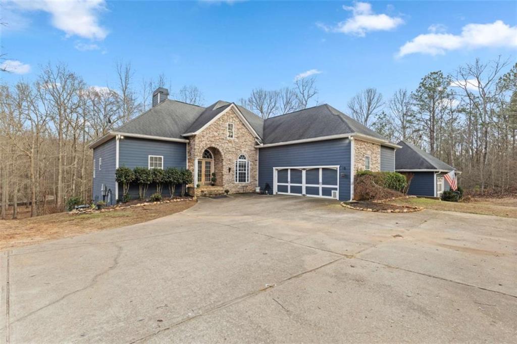 8399 East Carroll Road Whitesburg, GA 30185 - Photo 2 of 52 a front view of a house with a yard and garage