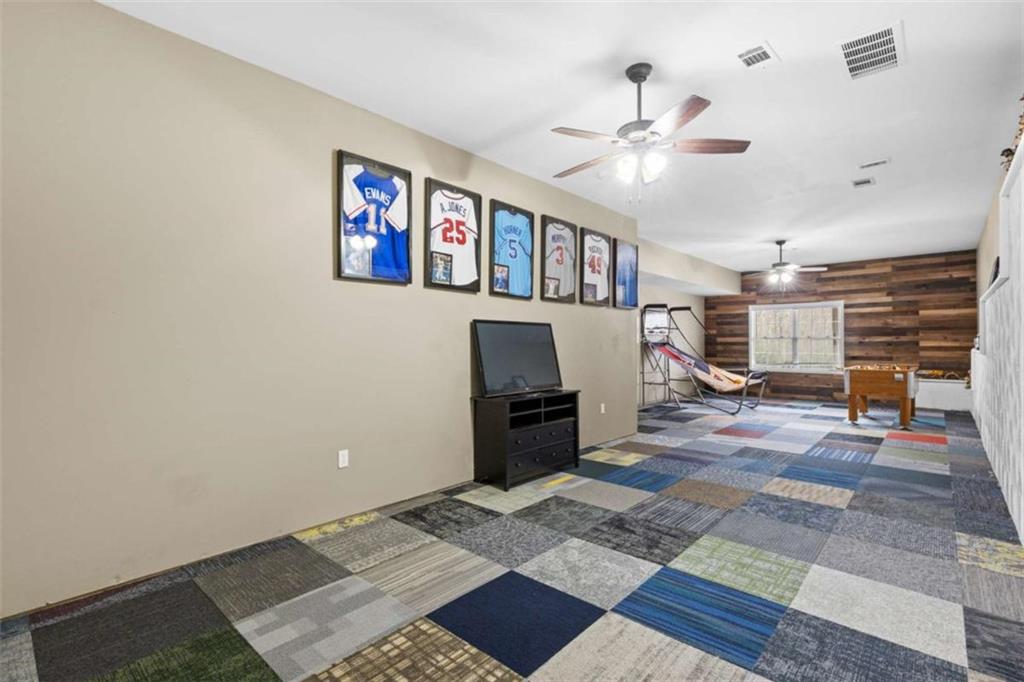 8399 East Carroll Road Whitesburg, GA 30185 - Photo 24 of 52 a living room with furniture and a flat screen tv