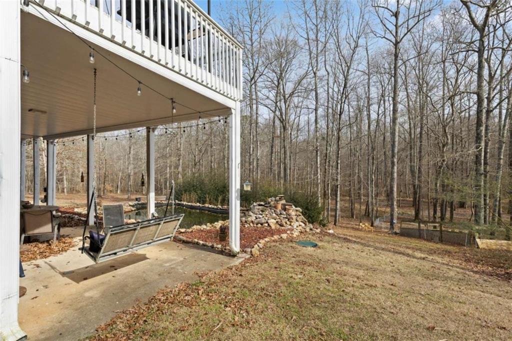 8399 East Carroll Road Whitesburg, GA 30185 - Photo 31 of 52 a backyard of a house with table and chairs