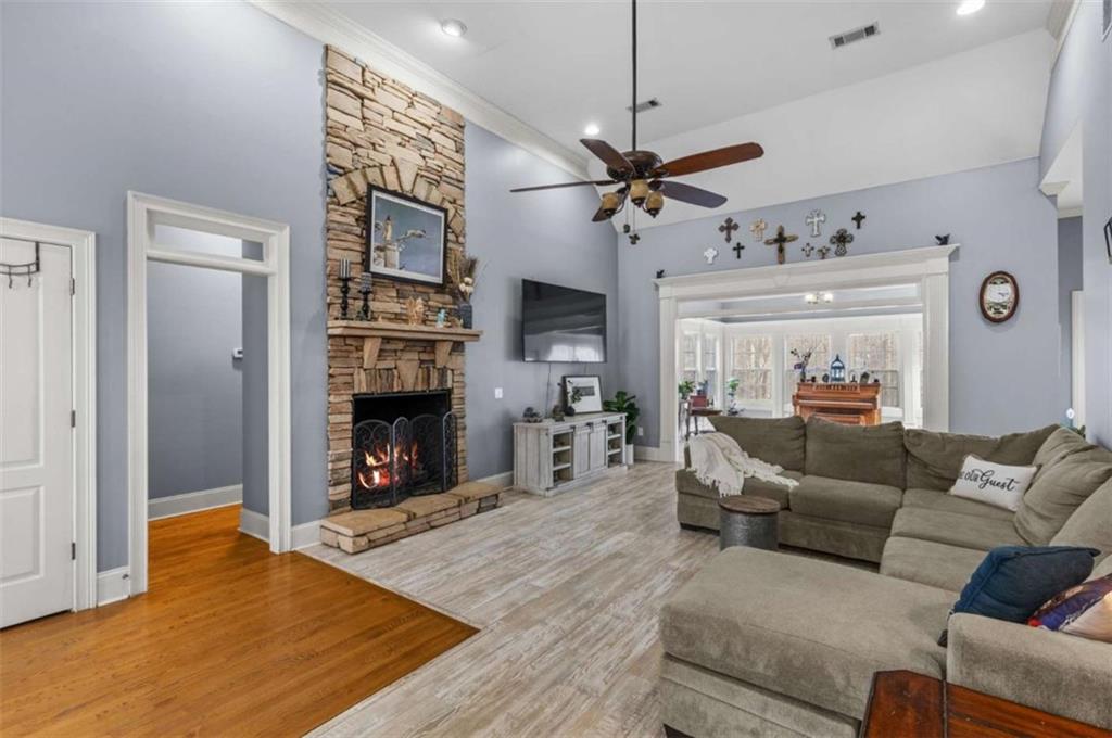 8399 East Carroll Road Whitesburg, GA 30185 - Photo 6 of 52 a living room with furniture a fireplace and a flat screen tv