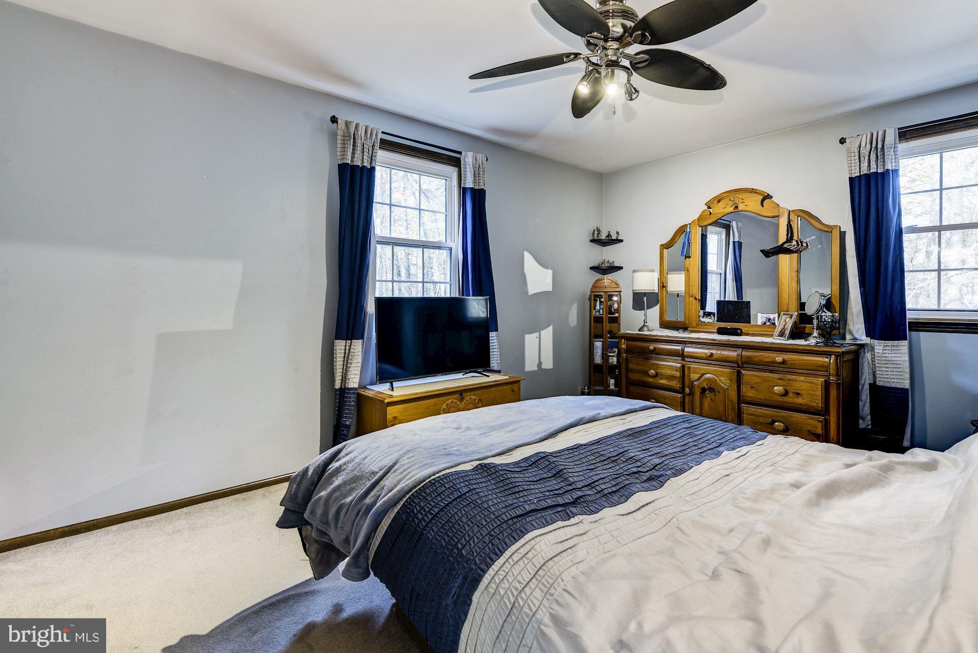 5 Spring Drive Tabernacle, NJ 08088 - Photo 12 of 29 a bedroom with a bed and a chandelier