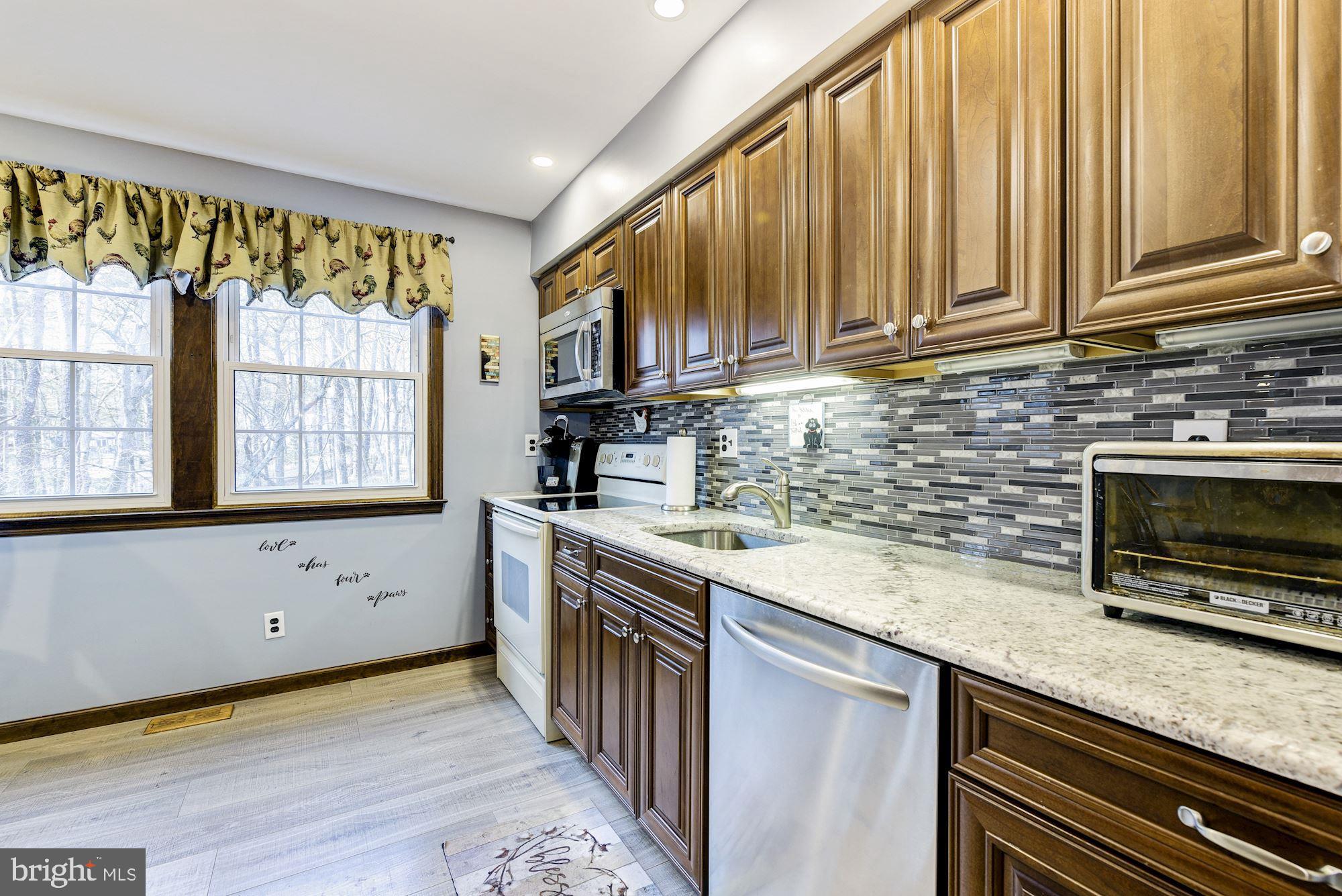 5 Spring Drive Tabernacle, NJ 08088 - Photo 9 of 29 a kitchen with stainless steel appliances granite countertop a stove a sink and a microwave