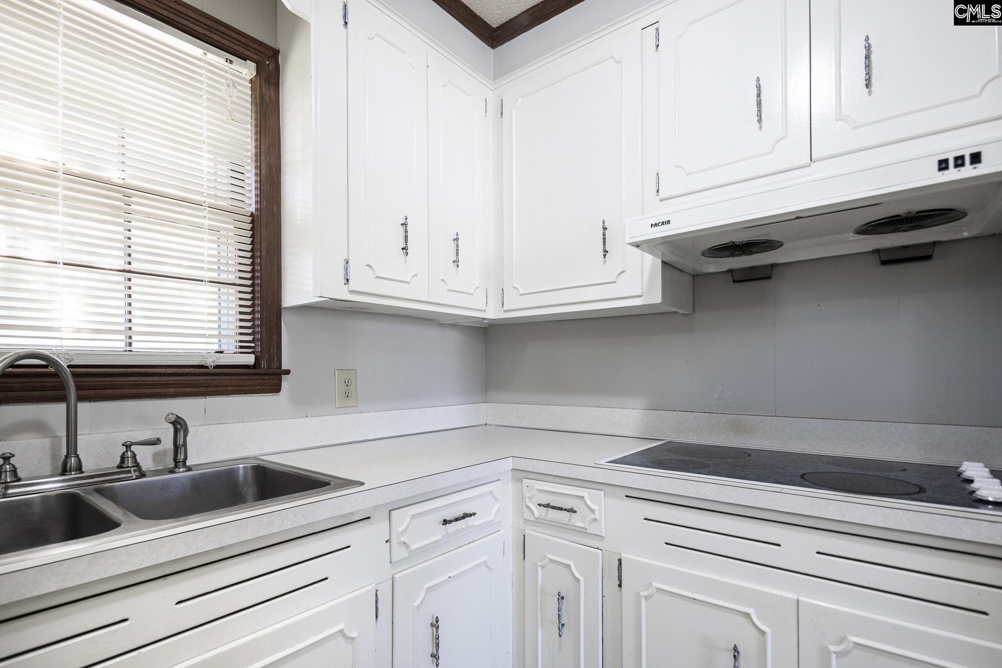 4083 Platt Springs Road West Columbia, SC 29170 - Photo 12 of 35 a kitchen with white cabinets and a window