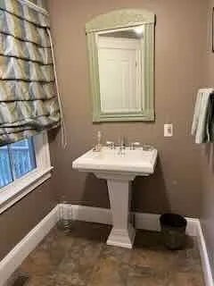 a bathroom with a sink a mirror and shower
