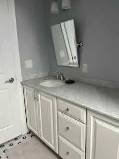 a bathroom with a sink and a mirror