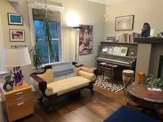 a living room with furniture and wooden floor