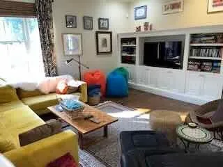 a living room with furniture and flat screen tv