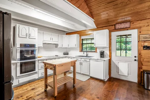 a kitchen with a stove a sink and a refrigerator