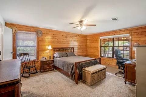 a spacious bedroom with a bed and a chandelier